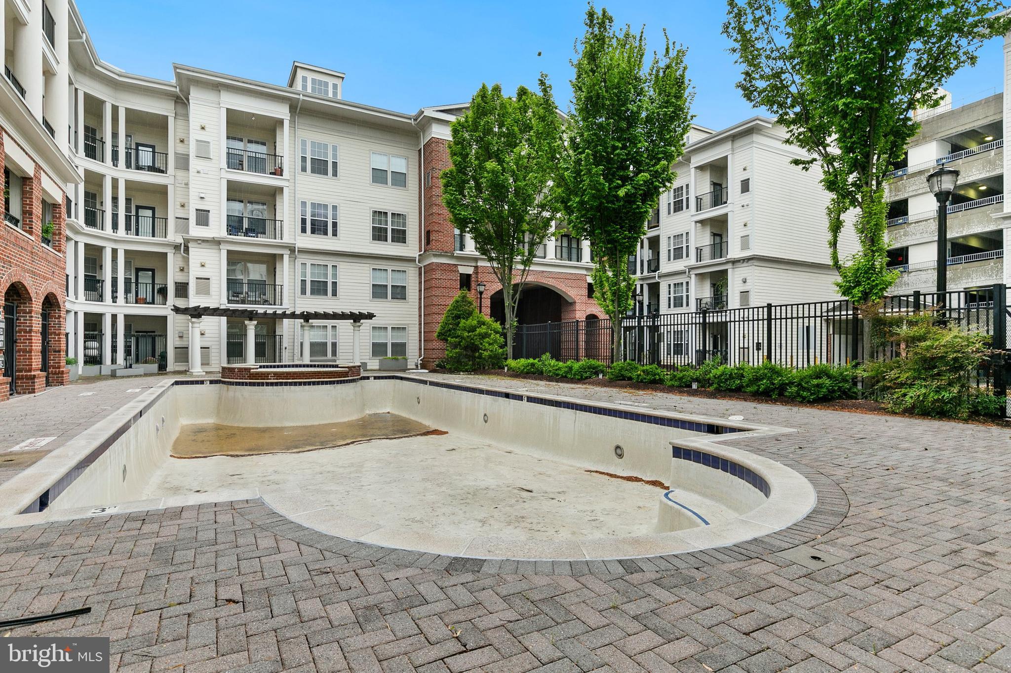 7 Granite Place, Unit 316 Gaithersburg, MD 20878 - Photo 58 of 84 a view of a white building with a swimming pool