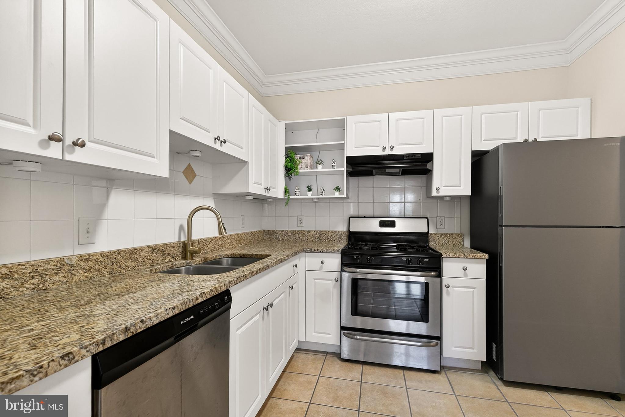 7 Granite Place, Unit 316 Gaithersburg, MD 20878 - Photo 6 of 84 a kitchen with granite countertop a stove sink and refrigerator