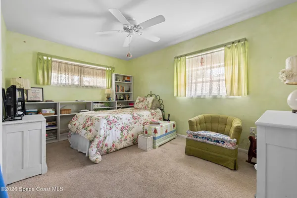 a bedroom with a bed couch and window