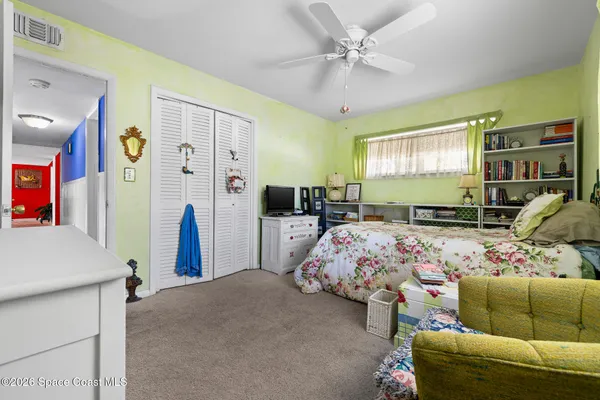 a bed room with furniture and a flat screen tv