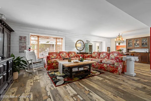 a living room with lots of furniture and a large window