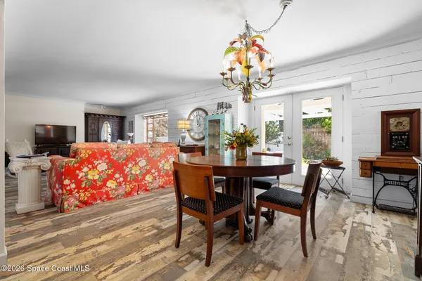 a view of a dining room with furniture and a chandelier