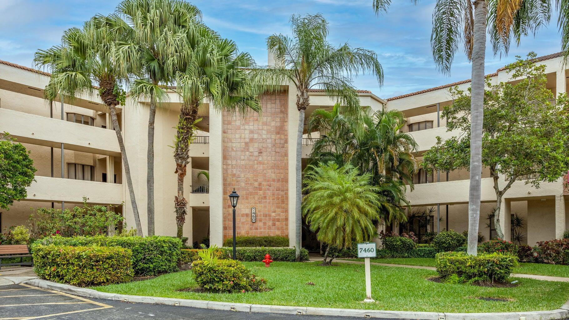 7460 La Paz Boulevard, Unit 208 Boca Raton, FL 33433 - Photo 1 of 23 front view of a house with a yard and potted plants