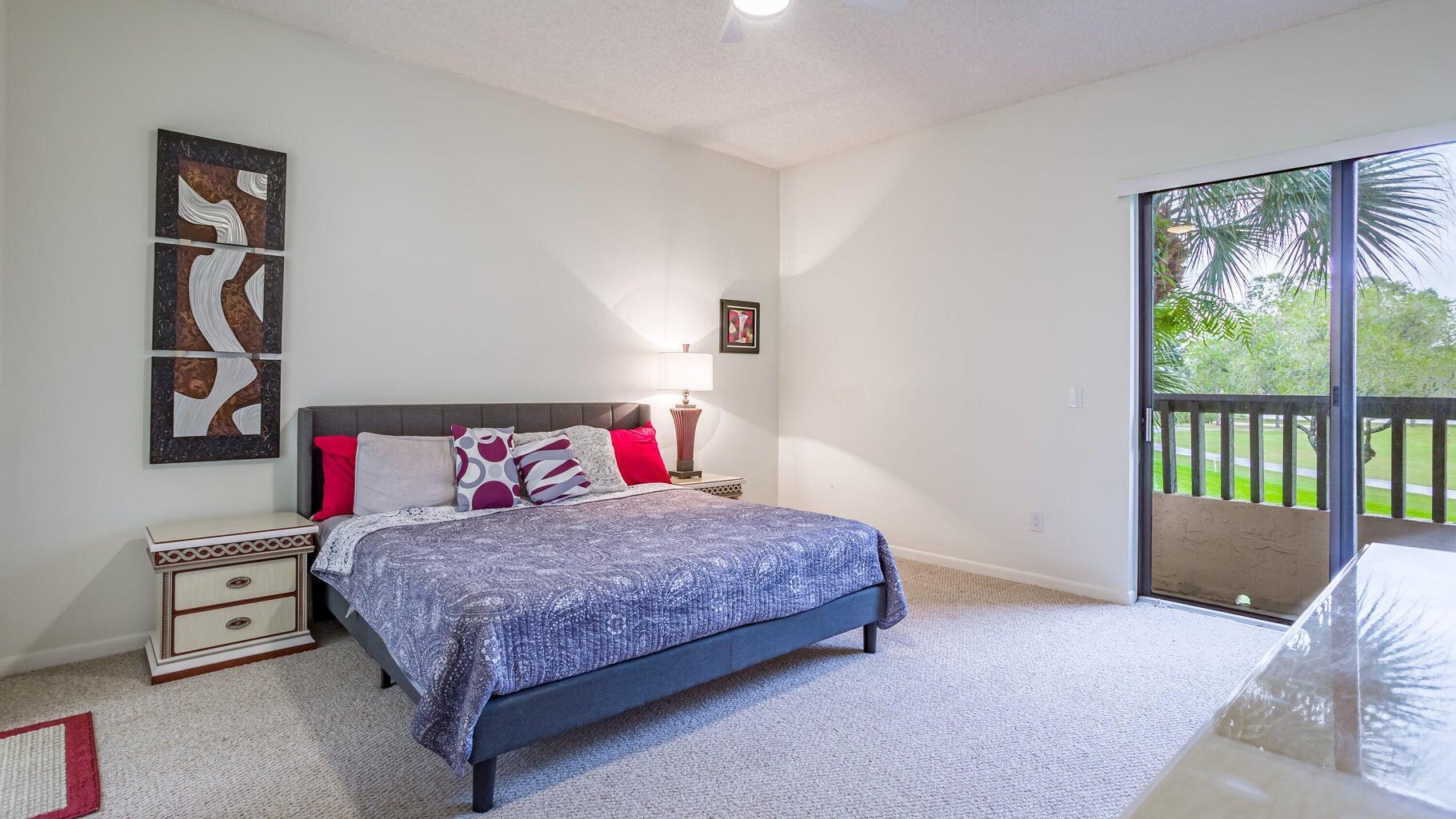 7460 La Paz Boulevard, Unit 208 Boca Raton, FL 33433 - Photo 11 of 23 a bedroom with a bed and a dresser next to a window
