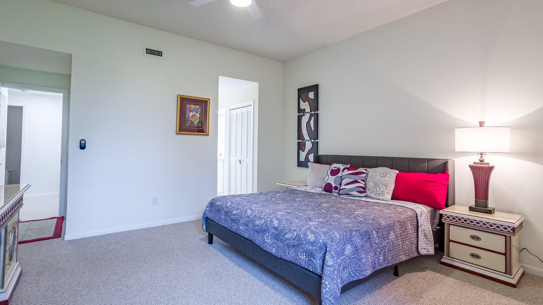 7460 La Paz Boulevard, Unit 208 Boca Raton, FL 33433 - Photo 12 of 23 a bedroom with a bed and a night stand