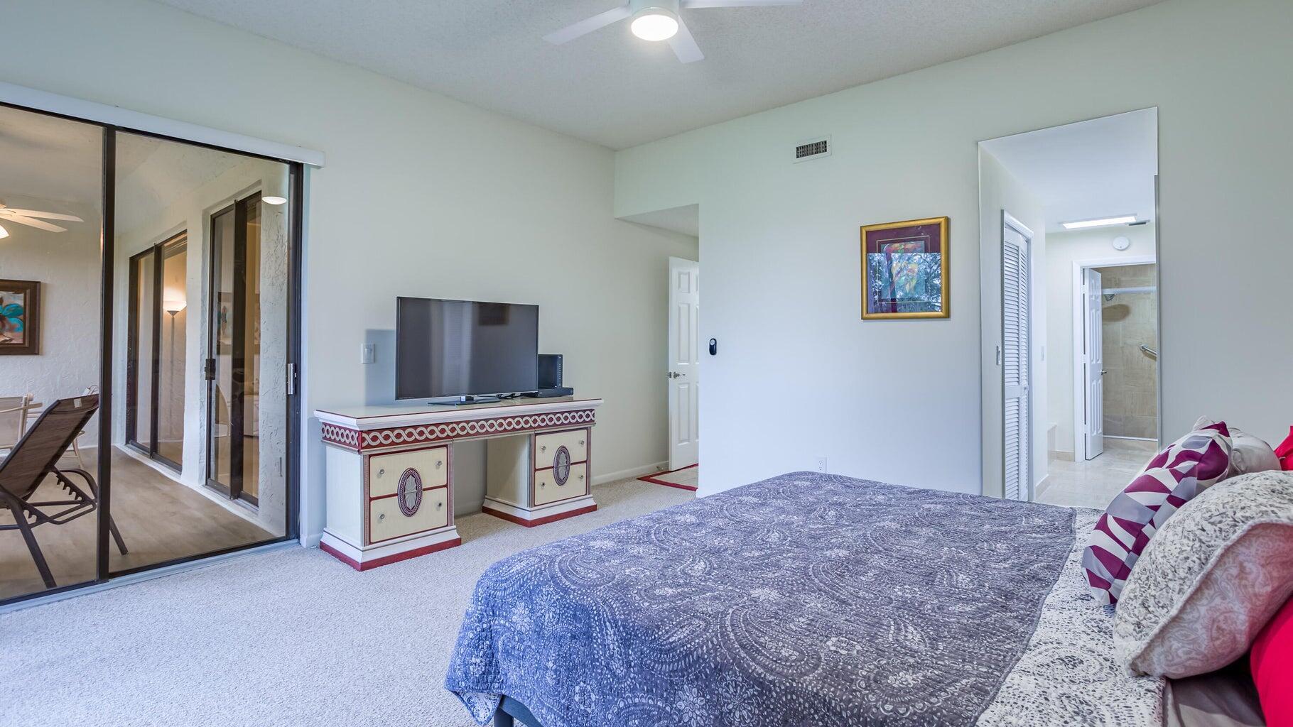 7460 La Paz Boulevard, Unit 208 Boca Raton, FL 33433 - Photo 13 of 23 a bedroom with a bed and a television