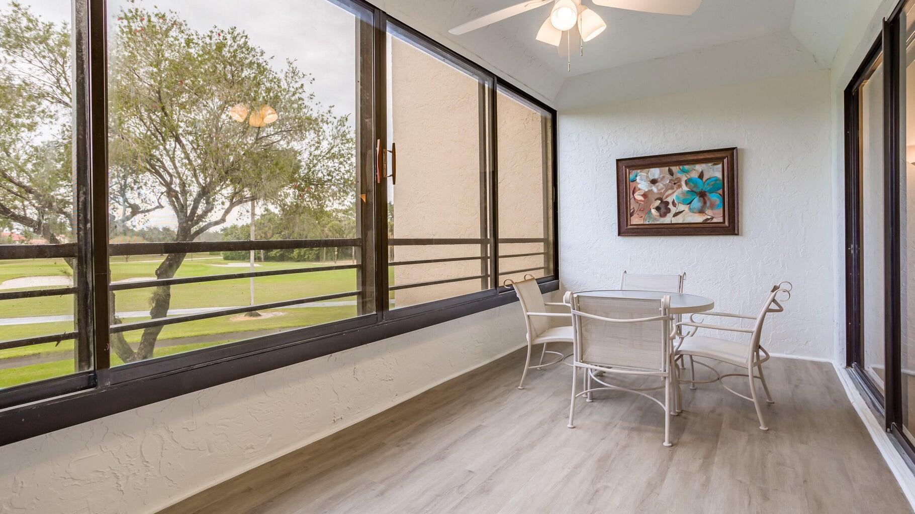 7460 La Paz Boulevard, Unit 208 Boca Raton, FL 33433 - Photo 21 of 23 a view of a dining room with furniture window and wooden floor
