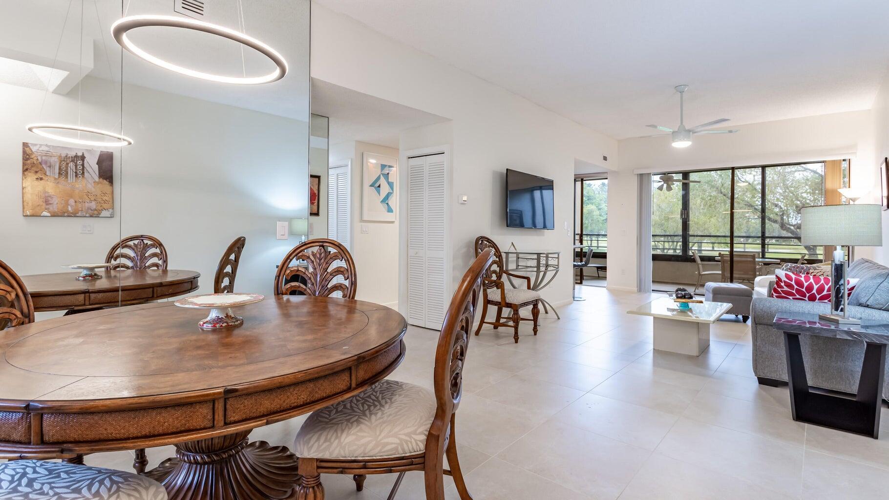 7460 La Paz Boulevard, Unit 208 Boca Raton, FL 33433 - Photo 3 of 23 a dining room with furniture and wooden floor