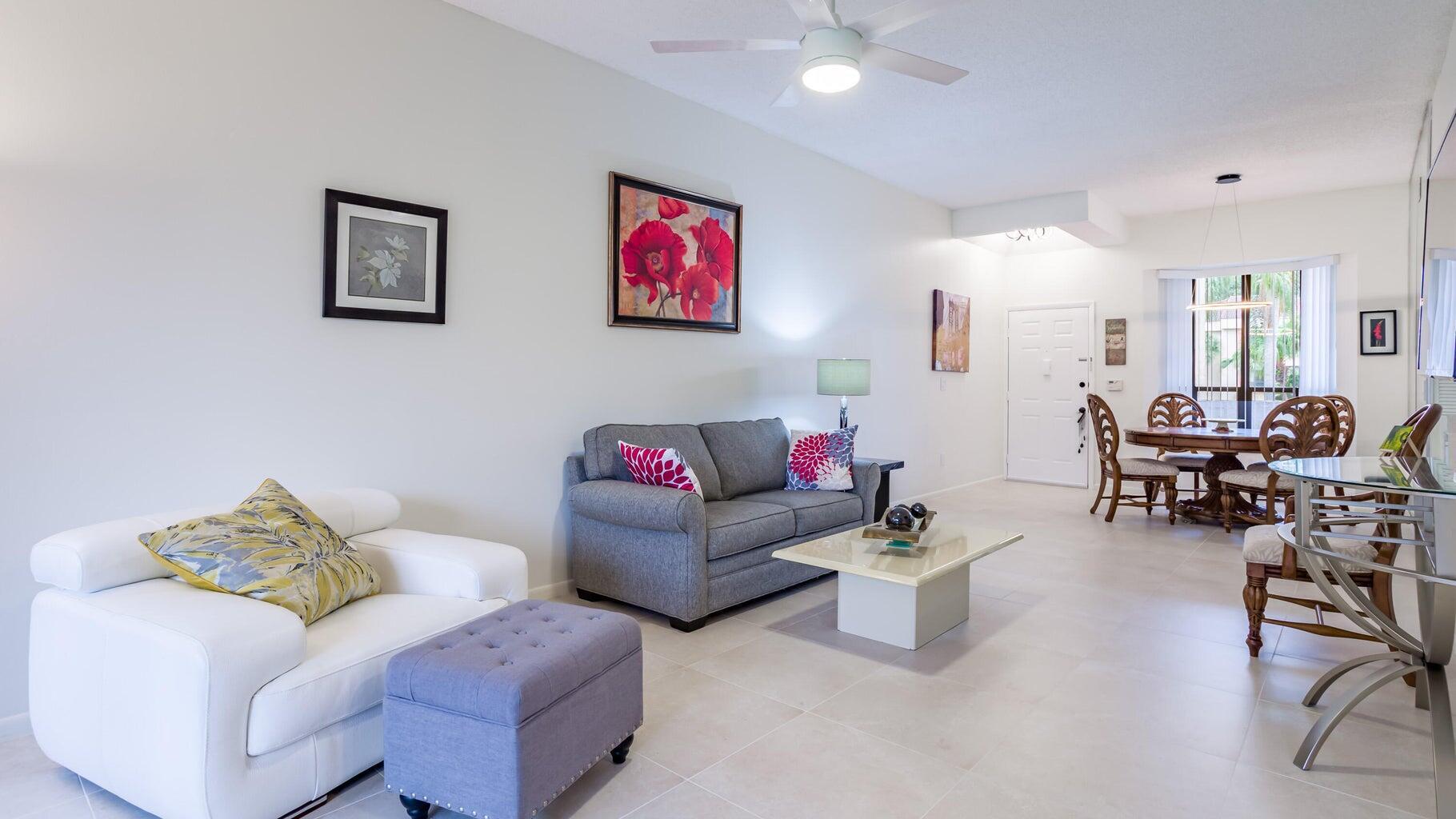 7460 La Paz Boulevard, Unit 208 Boca Raton, FL 33433 - Photo 5 of 23 a living room with furniture and white walls