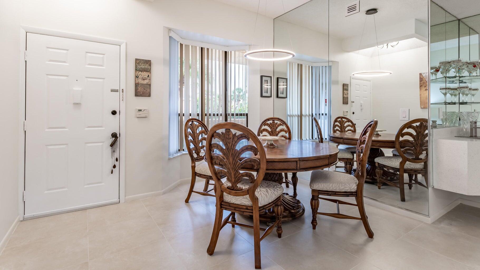 7460 La Paz Boulevard, Unit 208 Boca Raton, FL 33433 - Photo 6 of 23 a view of a dining room with furniture