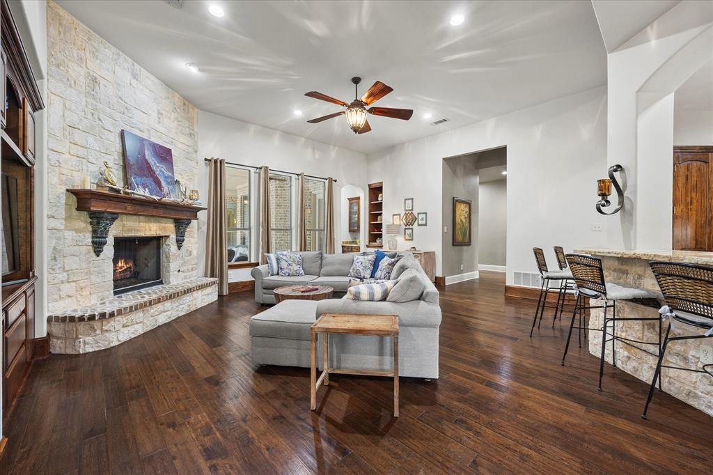 1704 White Road Heath, TX 75032 - Photo 16 of 28 a living room with furniture a fireplace and wooden floor
