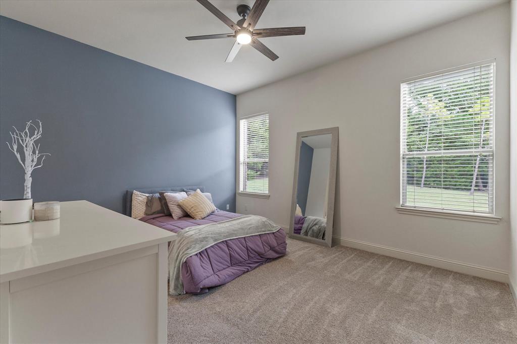 1704 White Road Heath, TX 75032 - Photo 23 of 28 a bedroom with a bed and a table