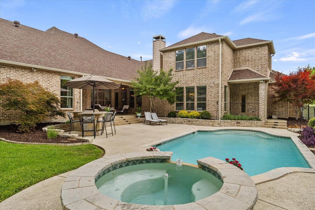 1704 White Road Heath, TX 75032 - Photo 8 of 28 a front view of house with a garden and swimming pool
