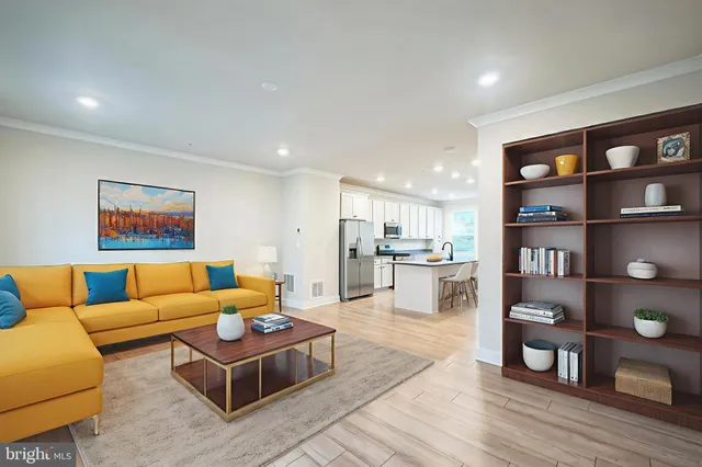 a living room with furniture and a book shelf