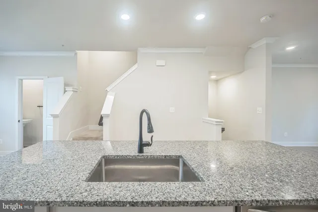 a kitchen with kitchen island a sink and refrigerator