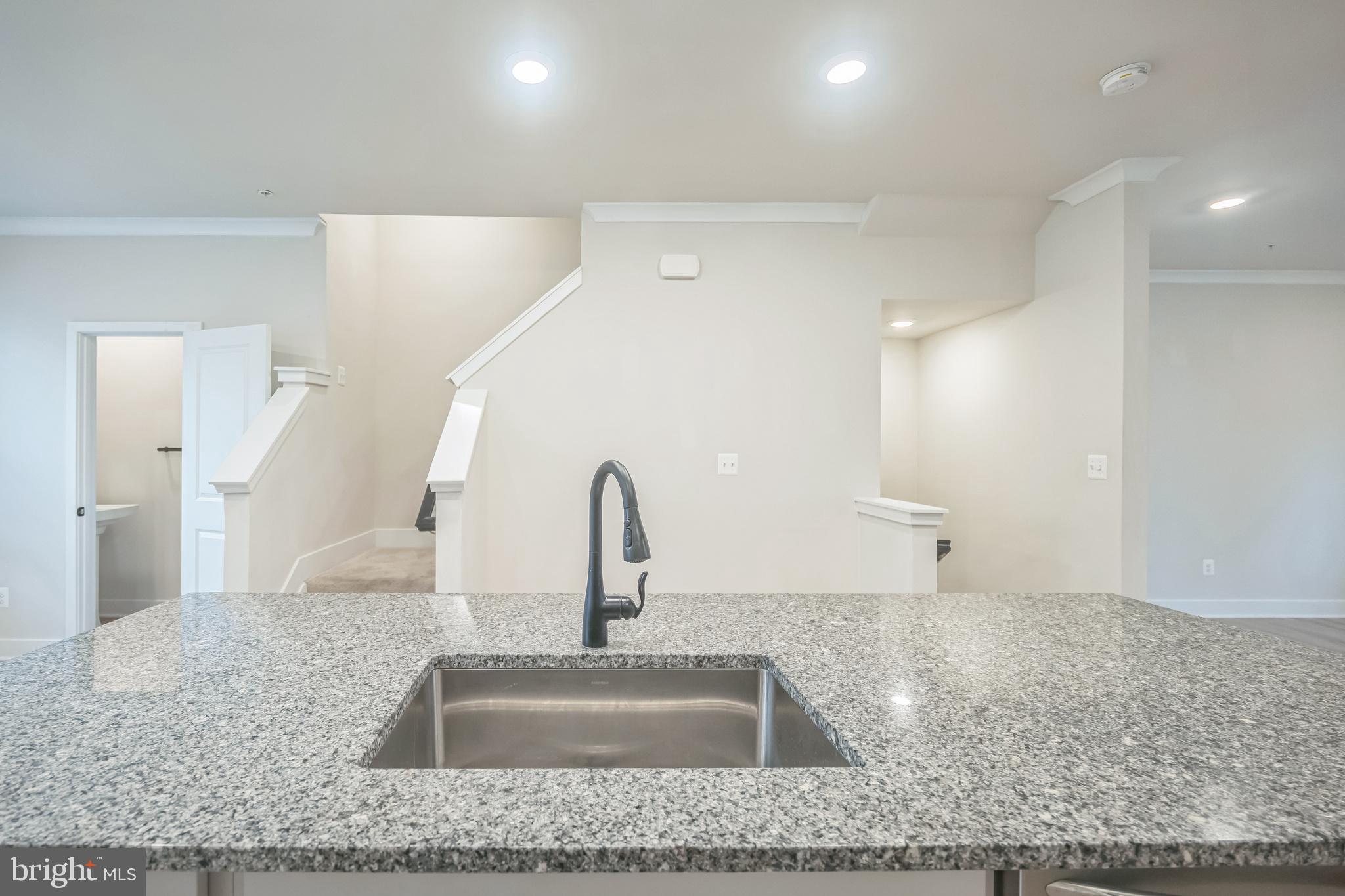 4402 Roland Heights Avenue Baltimore, MD 21211 - Photo 12 of 47 a kitchen with kitchen island a sink and refrigerator