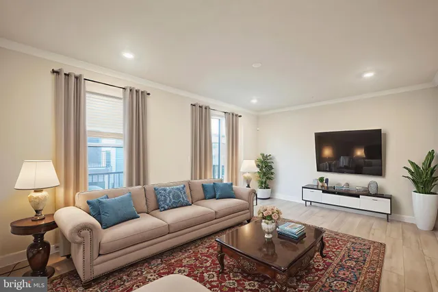 a living room with furniture a flat screen tv and a large window