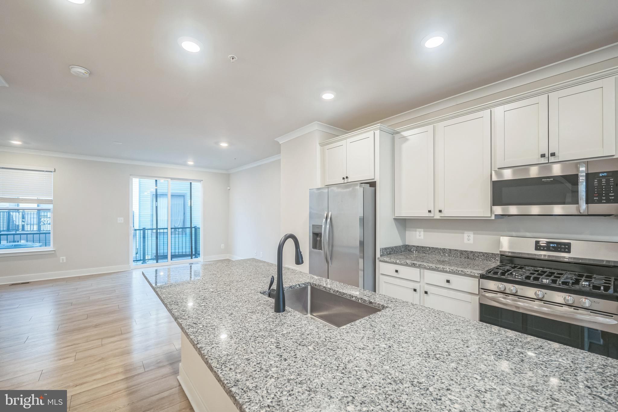 4402 Roland Heights Avenue Baltimore, MD 21211 - Photo 19 of 47 a kitchen with stainless steel appliances granite countertop a sink stove and refrigerator
