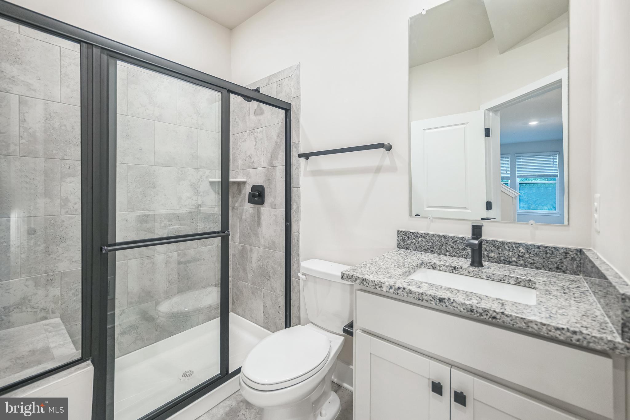 4402 Roland Heights Avenue Baltimore, MD 21211 - Photo 22 of 47 a bathroom with a granite countertop sink toilet and shower