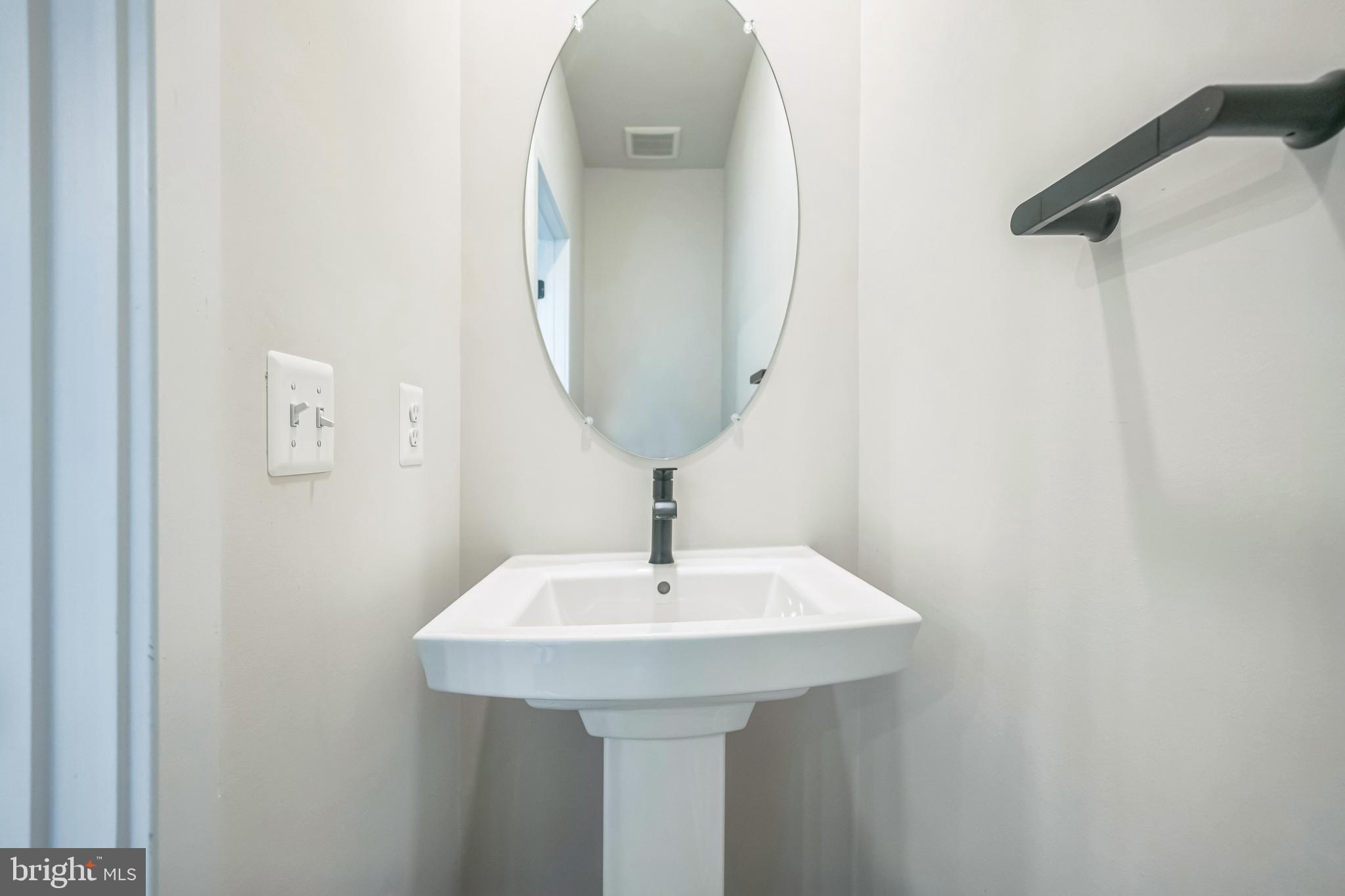 4402 Roland Heights Avenue Baltimore, MD 21211 - Photo 27 of 47 a bathroom with a sink and mirror