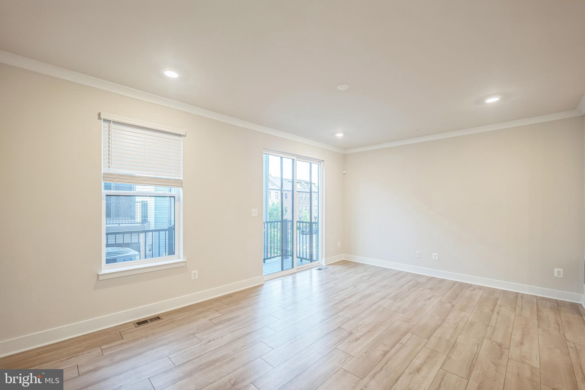 4402 Roland Heights Avenue Baltimore, MD 21211 - Photo 29 of 47 an empty room with wooden floor and windows