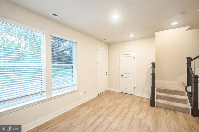 a view of a room with wooden floor and window