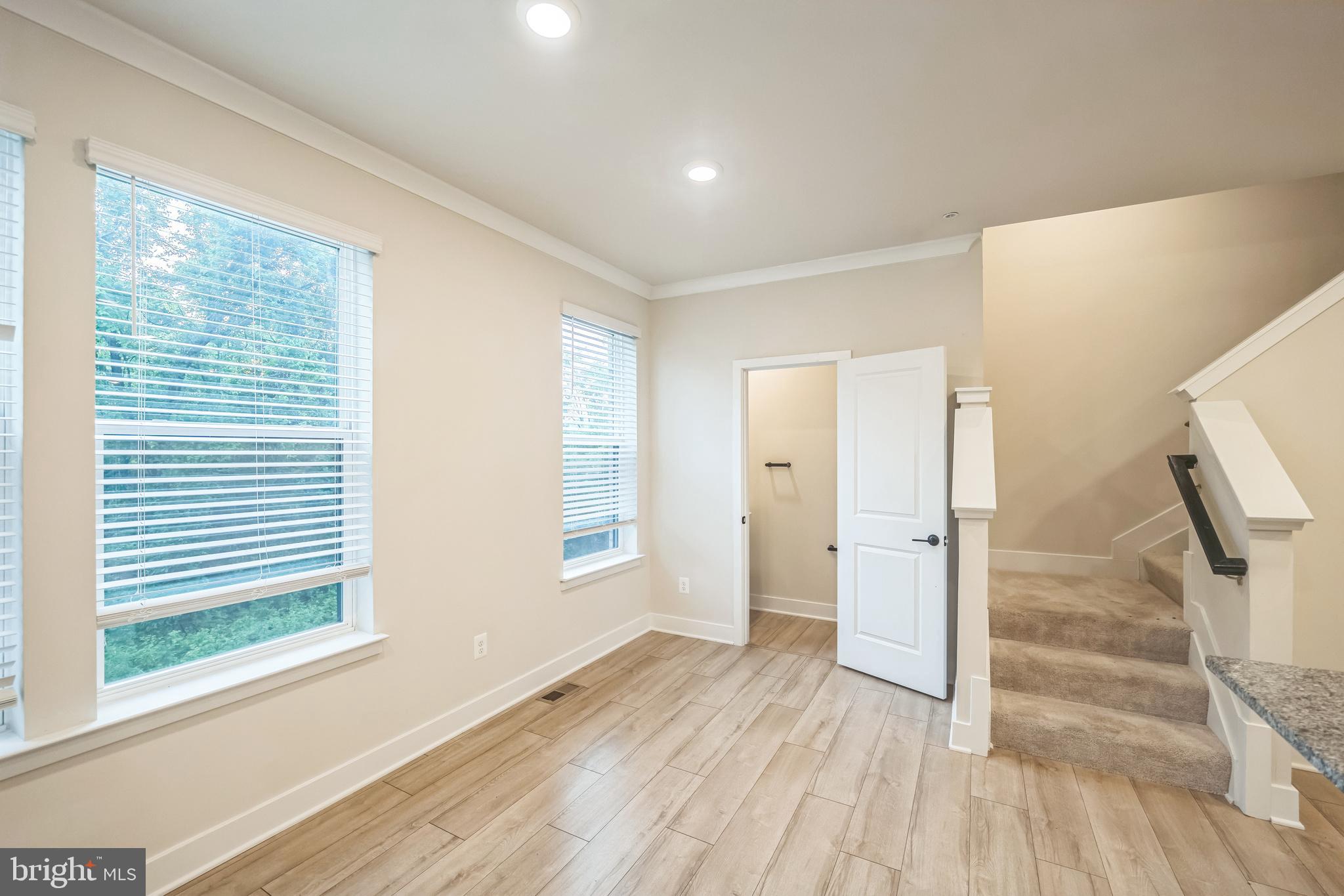 4402 Roland Heights Avenue Baltimore, MD 21211 - Photo 4 of 47 a view of empty room with wooden floor and fan