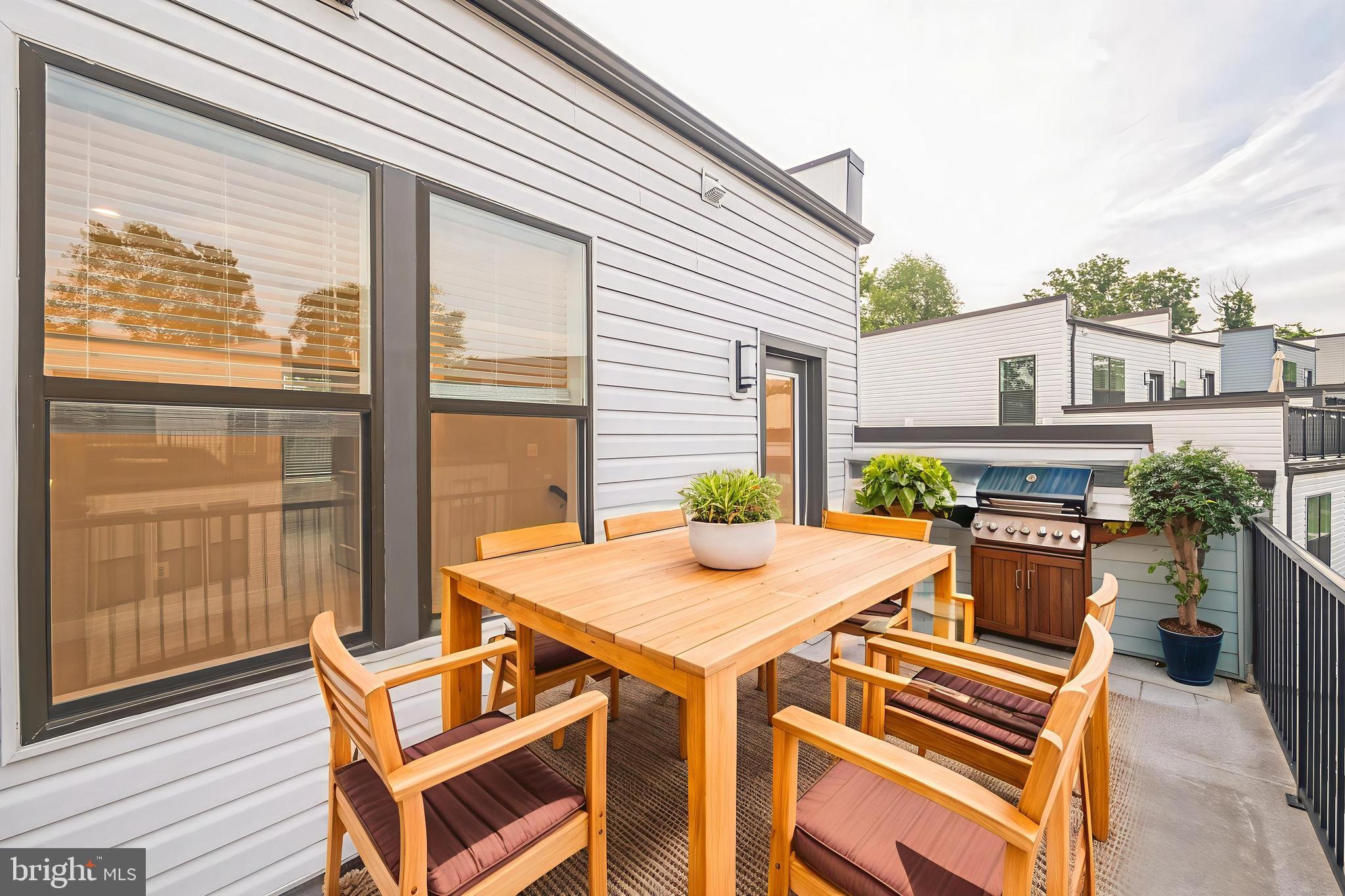4402 Roland Heights Avenue Baltimore, MD 21211 - Photo 43 of 47 a view of a patio with table and chairs and potted plants