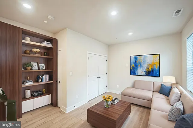 a living room with furniture and wooden floor