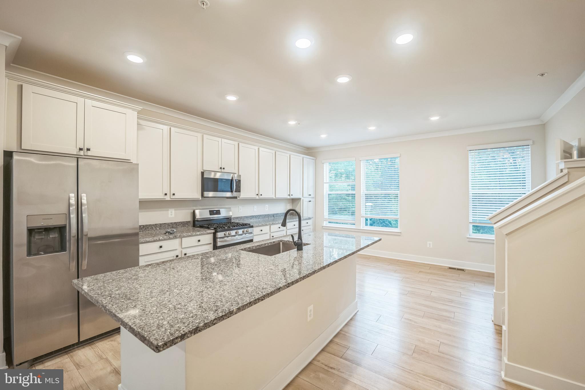 4402 Roland Heights Avenue Baltimore, MD 21211 - Photo 10 of 47 a kitchen with stainless steel appliances granite countertop a sink stove and refrigerator