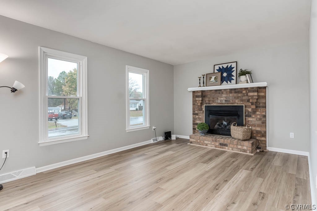 8117 Valencia Road Chesterfield, VA 23832 - Photo 6 of 30 a view of an empty room with wooden floor fireplace and a window