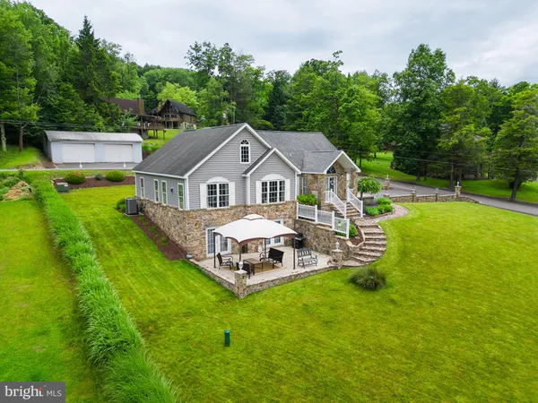 a aerial view of a house with swimming pool and garden view