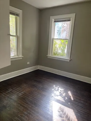 a view of room with wooden floor and window