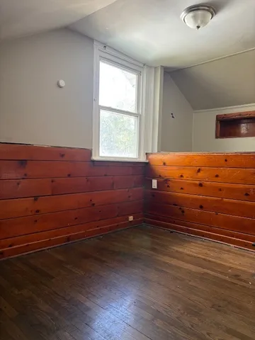 a room with wooden floor and window