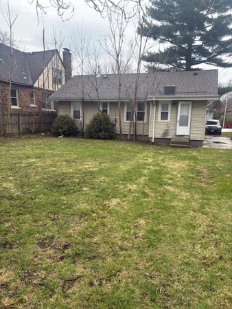 a view of a house with a backyard