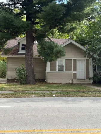 a house that has a tree in front of it