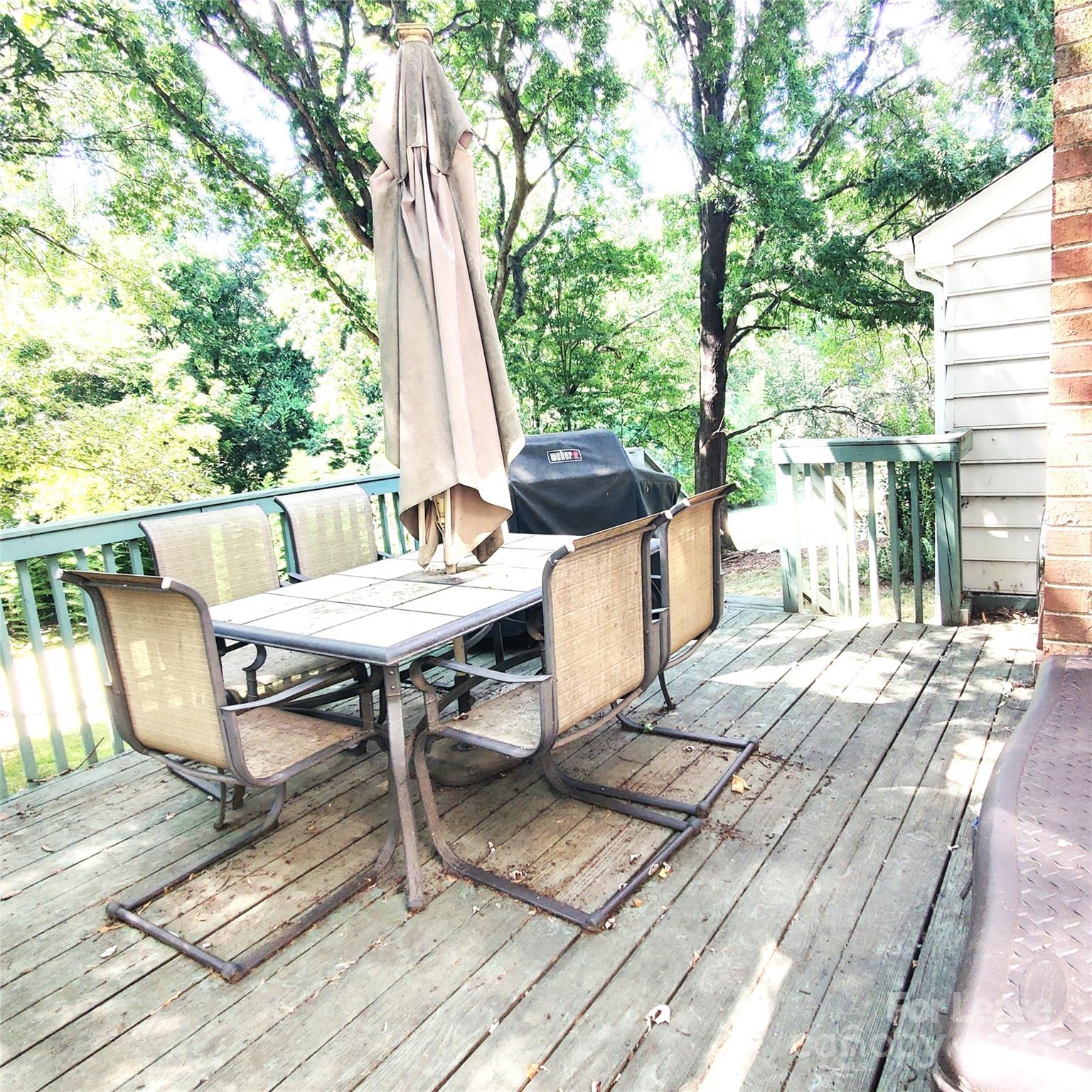 8644 Kirchenbaum Drive Charlotte, NC 28210 - Photo 25 of 28 a view of a patio with table and chairs and wooden floor