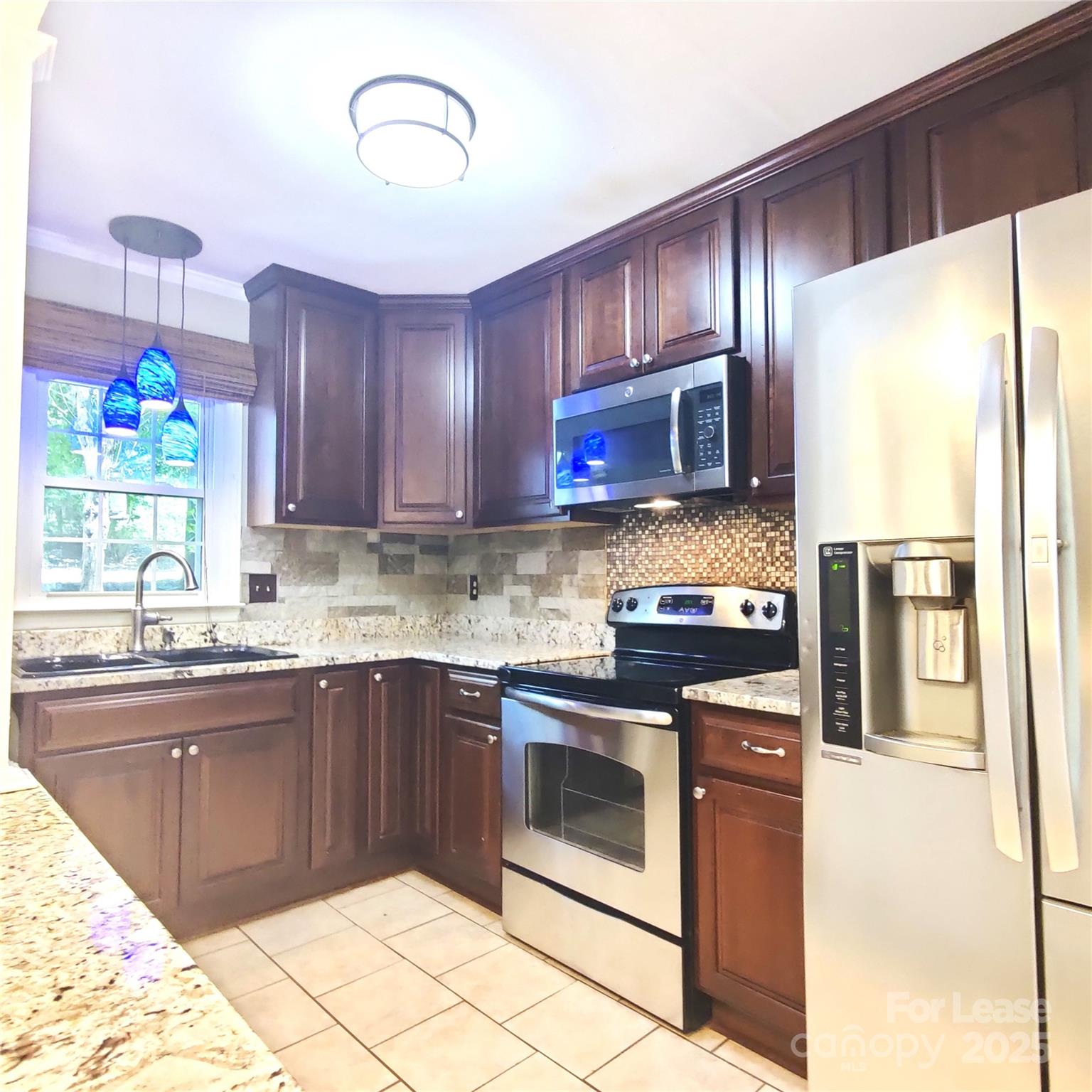 8644 Kirchenbaum Drive Charlotte, NC 28210 - Photo 4 of 28 a kitchen with stainless steel appliances granite countertop wooden cabinets a stove top oven a sink and dishwasher