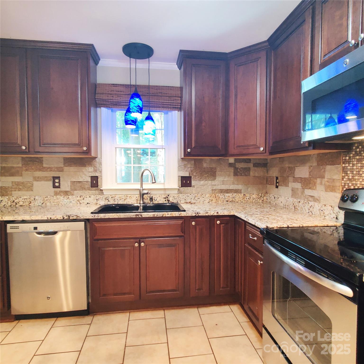 8644 Kirchenbaum Drive Charlotte, NC 28210 - Photo 5 of 28 a kitchen with kitchen island granite countertop a stove sink and cabinets