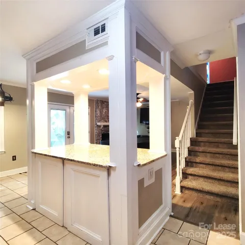 a view of an entryway with wooden floor and cabinet