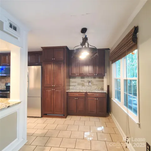 a kitchen with stainless steel appliances granite countertop a refrigerator and a sink