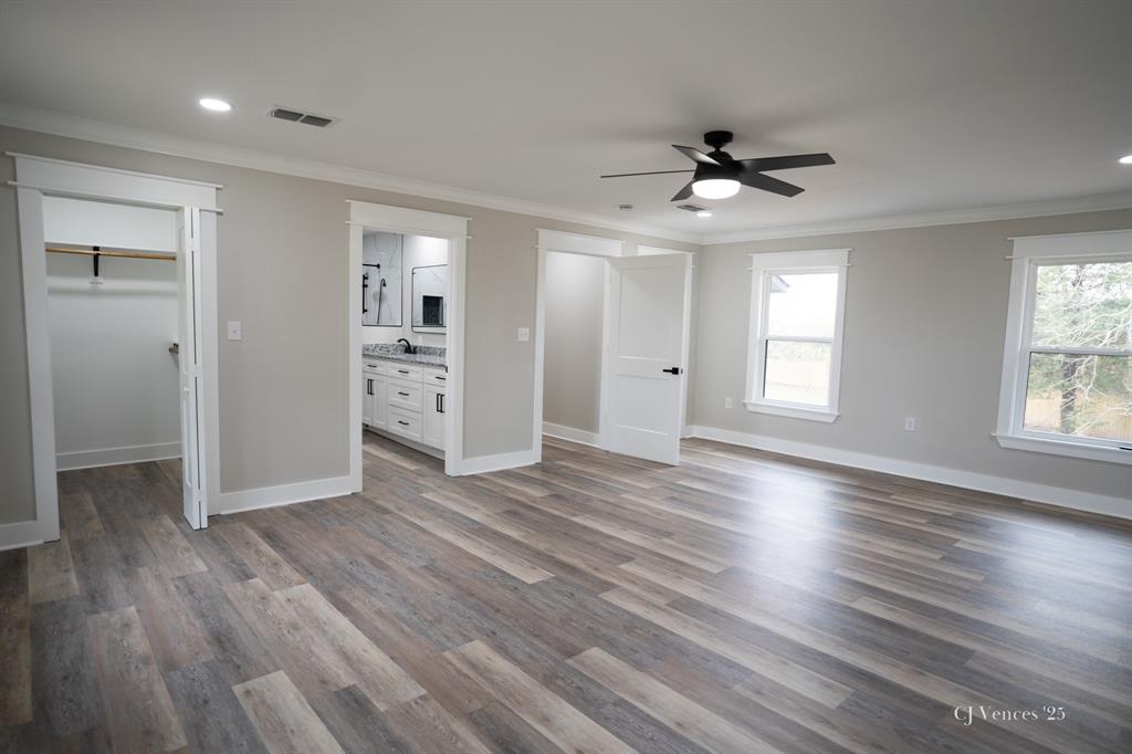 642 Circle M Drive Grand Cane, LA 71032 - Photo 17 of 40 an empty room with wooden floor cabinet and windows
