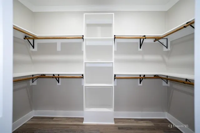 a view of walk in closet with empty racks