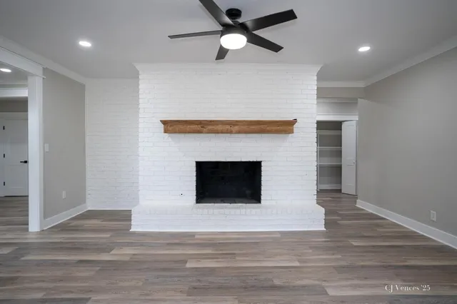 a view of a livingroom with a fireplace and a ceiling fan