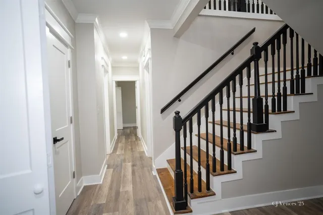 a view of entryway with wooden floor and stairs