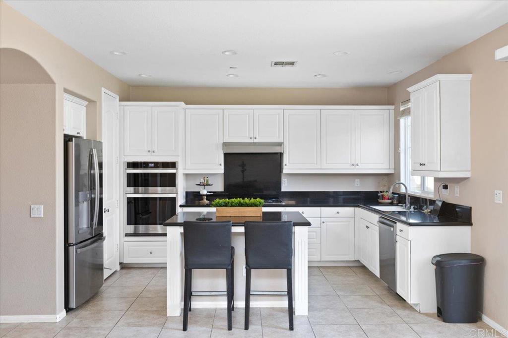 4163 Lake Cir Drive Fallbrook, CA 92028 - Photo 6 of 34 a kitchen with stainless steel appliances a stove a sink a refrigerator and cabinets