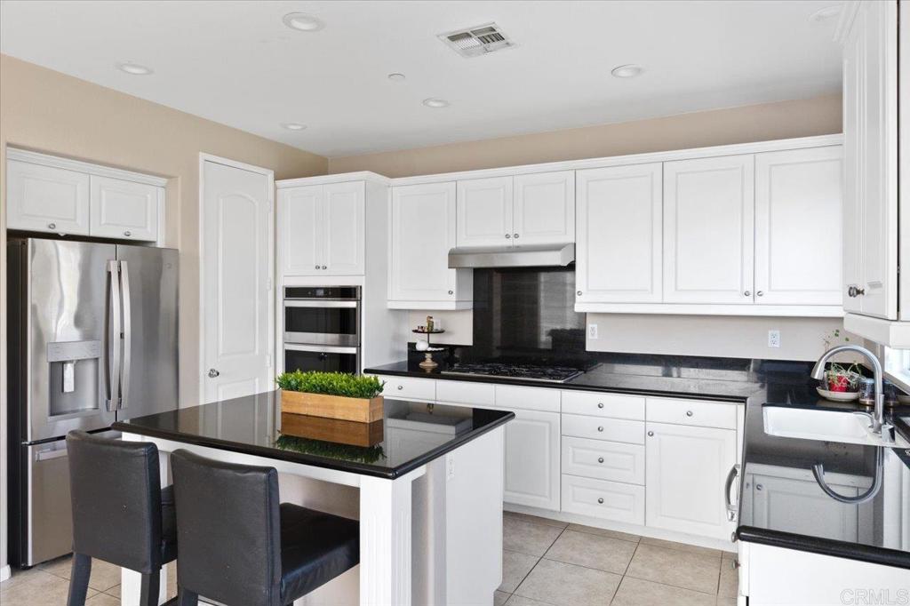 4163 Lake Cir Drive Fallbrook, CA 92028 - Photo 7 of 34 a kitchen with granite countertop a sink stove and cabinets