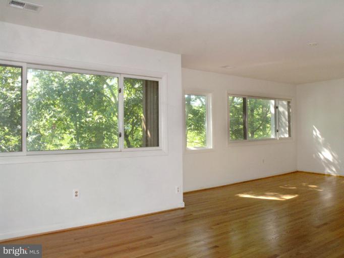 1646 Waters Edge Lane Reston, VA 20190 - Photo 17 of 30 an empty room with wooden floor and windows