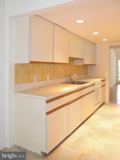 1646 Waters Edge Lane Reston, VA 20190 - Photo 19 of 30 a kitchen with a sink cabinets and white appliances