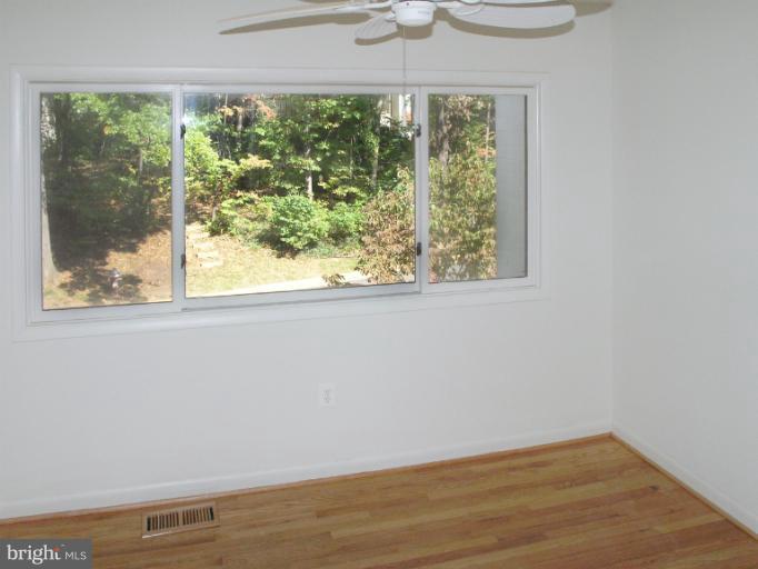 1646 Waters Edge Lane Reston, VA 20190 - Photo 21 of 30 an empty room with wooden floor and outdoor space
